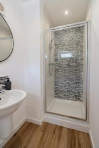 a bathroom with a shower and a sink at The Willows in Hurlet +22 photos