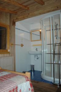 a bathroom with a bed and a sink in a room at Appartements Giffre et Clesson - DAHU COMPAGNIE in Samoëns