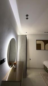 a living room with a mirror and a table at Spacious Two-Bedroom Apartment with a Large Living Room, comfortable and well organized, perfect for a relaxing stay in Jeddah +27 photos