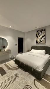 a bedroom with a large bed in a room at Spacious Two-Bedroom Apartment with a Large Living Room, comfortable and well organized, perfect for a relaxing stay in Jeddah