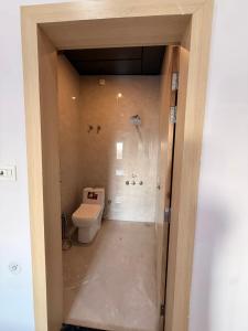 a bathroom with a toilet in a room at Sunrise stay in Chhatikara