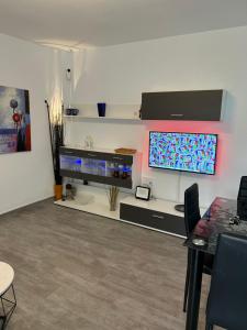 a living room with a table and a large screen tv at Apartment zona Naturista in Vera