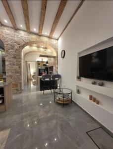 a living room with a large flat screen tv on a wall at Dalti Center Apartment in Zadar
