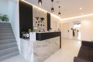 a lobby with a marble counter and stairs at Adele Hotel Ksamil in Ksamil