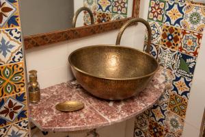 a copper bowl on a counter in a bathroom at Riad Rita in Meknès +148 photos