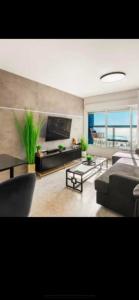 a living room with a couch and a table at דירה על הים in Ashdod