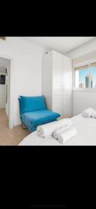 a room with two beds and a blue couch at דירה על הים in Ashdod +18 photos