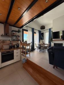 a kitchen and living room with a couch and a table at Damari Luxury 3 Bedroom Villas with Private Pool, Skiathos in Skiathos +140 photos