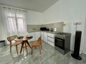 a kitchen with a table and a stove at Serenity villa in Pointe aux Biches +14 photos