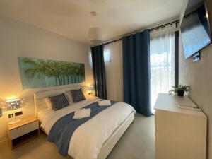 a bedroom with a large bed and a large window at Damari Luxury 3 Bedroom Villas with Private Pool, Skiathos in Skiathos