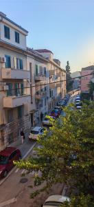 a city street with cars parked in front of buildings at Happy Dreams Apartment near the beach and old town in Split