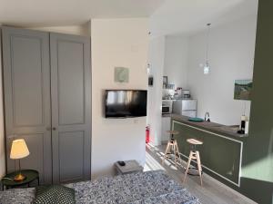 a bedroom with a bed and a kitchen with a counter at Rab Studio first floor 32m2 in Kampor
