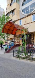 a building with awning on the side of a street at Old Town Apartment in Tashkent