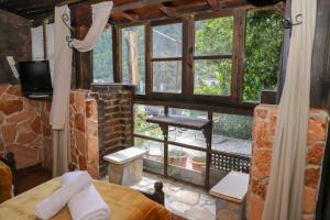 a room with a window and a bed and a tv at Hotel Nasho Vruho in Berat