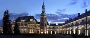 a large building with a tower on top of it at Host-X Pokoje Ciche Centrum Mała Sienkiewicza -fv in Kielce