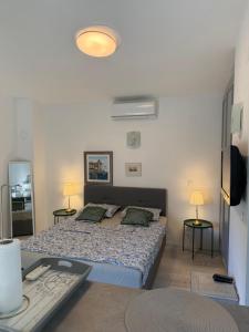 a bedroom with a bed and a desk with a keyboard at Rab Studio first floor 32m2 in Kampor