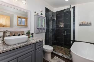 a bathroom with a sink and a toilet and a shower at Stylish Elysian Big Bear Cabin w Enclosed backyard in Big Bear City