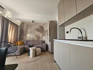 a living room with a couch and a kitchen at Brand New seaside Apartments NOA & JAKOV, Zaboric Sibenik in Zaboric