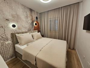 a bedroom with a bed with white sheets at Brand New seaside Apartments NOA & JAKOV, Zaboric Sibenik in Zaboric +62 photos