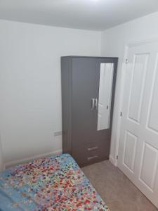 a bedroom with a bed and a mirror and a door at Edinburgh Road Nuneaton in Moffat