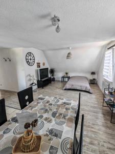 a living room with a large table in the middle of it at Gîte du logelbach in Wintzenheim