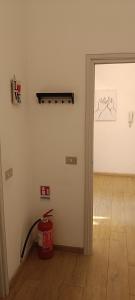 an empty room with a fire hydrant and a door at Modena Private Room in Modena