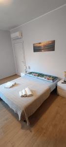 a bedroom with a large bed with two towels on it at Modena Private Room in Modena