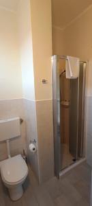 a bathroom with a toilet and a shower with a toilet paper roll at Modena Private Room in Modena