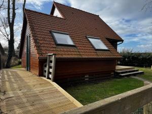 a house with a wooden walkway in front of it at Chalet confortable à Berck-sur-Mer in Berck-sur-Mer