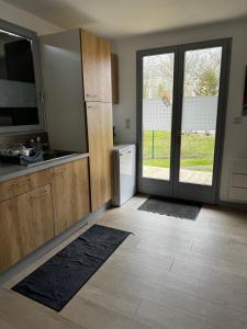 a kitchen with a sink and a sliding glass door at Chalet confortable à Berck-sur-Mer in Berck-sur-Mer +22 photos