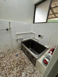 a dirty bathroom with a sink in the floor at 民泊大浦崎荘 in Kure +22 photos