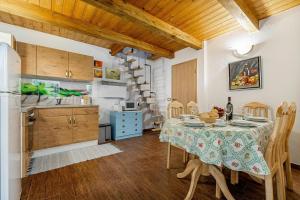 a kitchen and dining room with a table and chairs at Ladybug House Nature Retreat w/ Jacuzzi - Happy Rentals in Fokovci