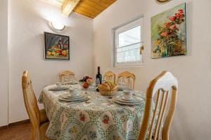 a dining room with a table and chairs at Ladybug House Nature Retreat w/ Jacuzzi - Happy Rentals in Fokovci