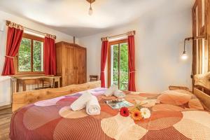 a bedroom with a large bed with towels on it at House By The Stream in Soča Valley - Happy Rentals in Avče