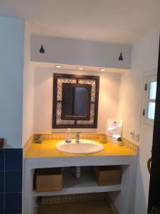 a bathroom with a sink and a mirror at Riad Louisa in Chefchaouen +34 photos