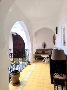 a living room with a couch and a table at Riad Louisa in Chefchaouen