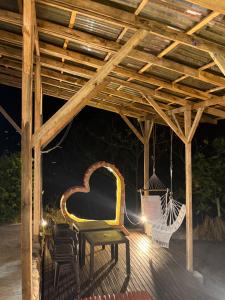 a wooden pergola with chairs and a swing at Paisa Territory Lodge in Jardin +7 photos