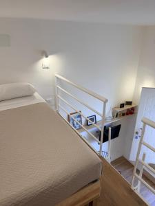 a bedroom with a bed and a stair case at Casetta Velia in Gaeta +8 photos