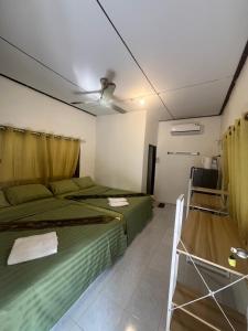 a bedroom with two beds and a ceiling fan at Pineapple Resort Sam roi yot in Sathani Sam Roi Yot