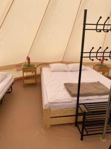 a bedroom with a bed in a tent at Glamping-Dimbo in Krynica Zdrój