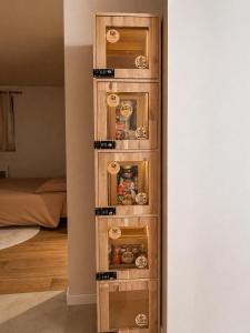 a tall wooden shelf with food in a room at Cocon suspendu in Pont-en-Royans
