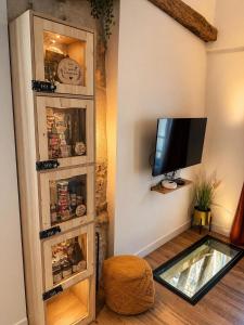a living room with a tv and a glass floor at Maison suspendue avec jacuzzi privatif in Pont-en-Royans
