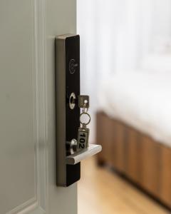 a lock on a door with a key in it at Kulla e Sahatit - Boutique Hotel in Old Bazaar in Gjakove +19 photos
