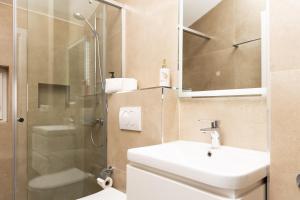 a bathroom with a sink and a shower at Kulla e Sahatit - Boutique Hotel in Old Bazaar in Gjakove