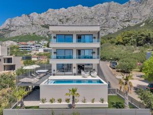 an aerial view of a house with a swimming pool at Villa Reina in Makarska