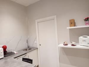 a white kitchen with a sink and a counter at D'Canteira in Redondela