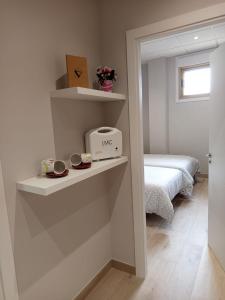 a room with a room with a bed and shelves at D'Canteira in Redondela