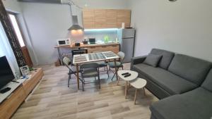 a living room with a couch and a table with chairs at Velipoja Home in Velipojë