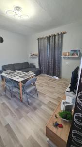 a living room with a table and a couch at Velipoja Home in Velipojë