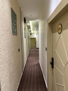 a corridor of a hallway with a long hallway at Divine Hotel in Karnal +2 photos